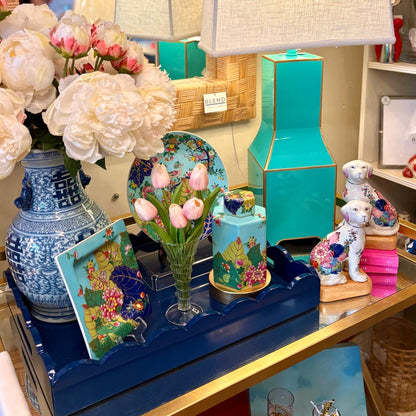 Display of decorative items including a blue lamp, vases, and figurines in a store setting.