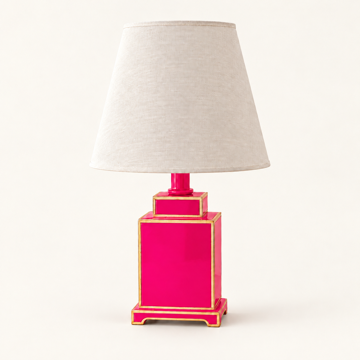 Mini Tole Tea Jar Lamp in Hot Pink with gold trim and a linen shade, on an ivory studio background